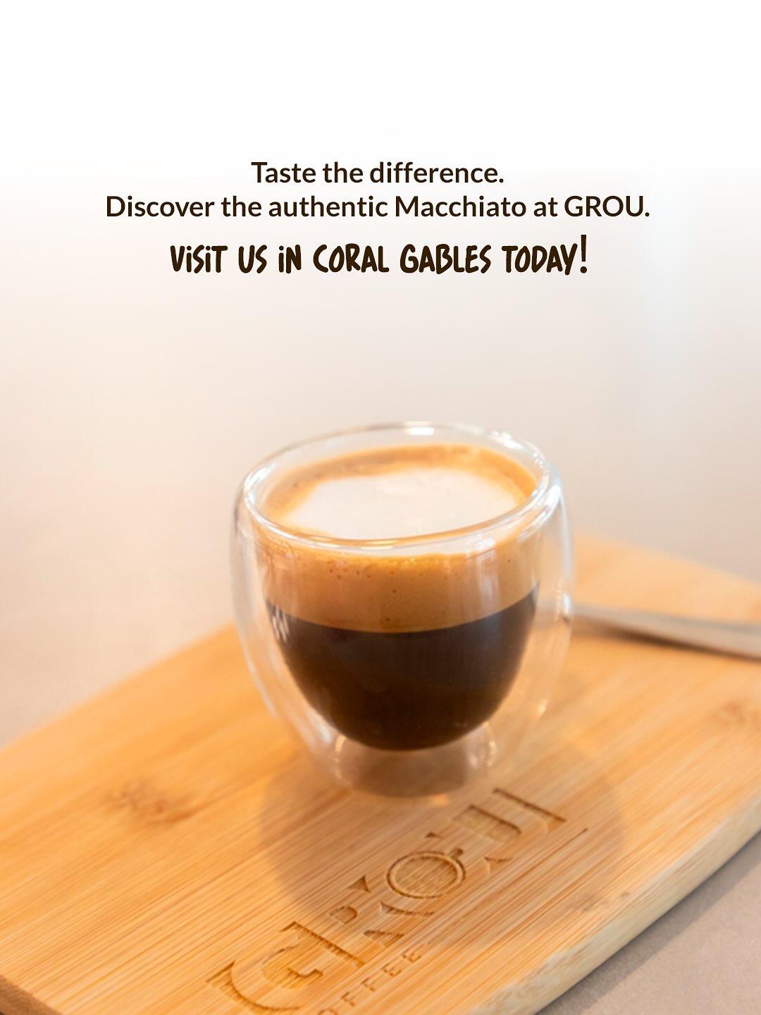 Macchiato in a small glass on a GROU wooden board, with text inviting you to discover it at GROU in Coral Gables