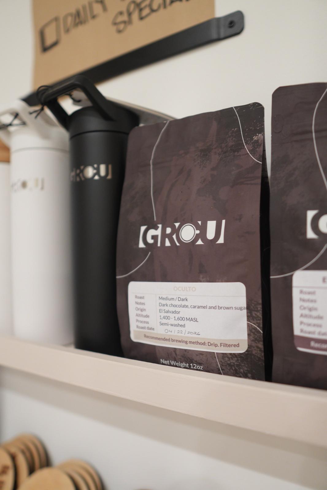 GROU Oculto coffee bag and its label on a shelf beside GROU insulated bottles