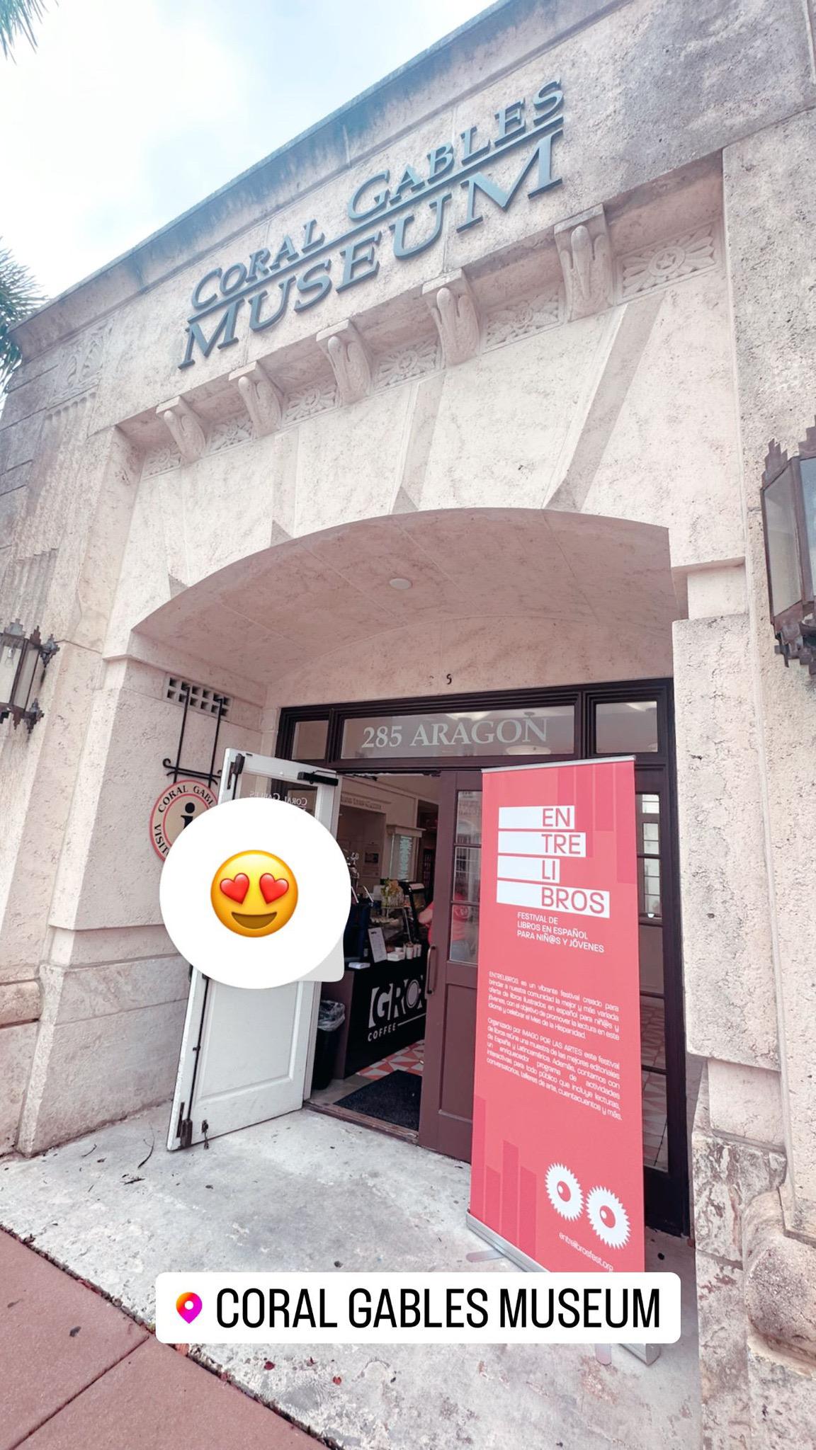 Entrance of the Coral Gables Museum at 285 Aragon with an EntreLibros banner and the GROU Coffee counter inside